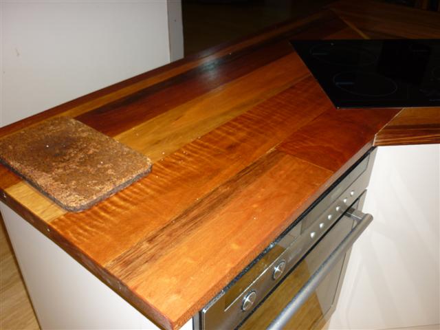 a wood counter top sitting above an oven