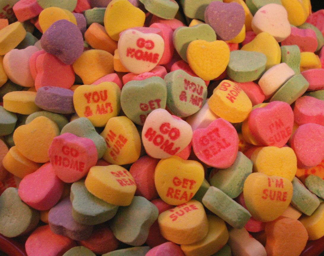 candy candies with conversation hearts on them are displayed