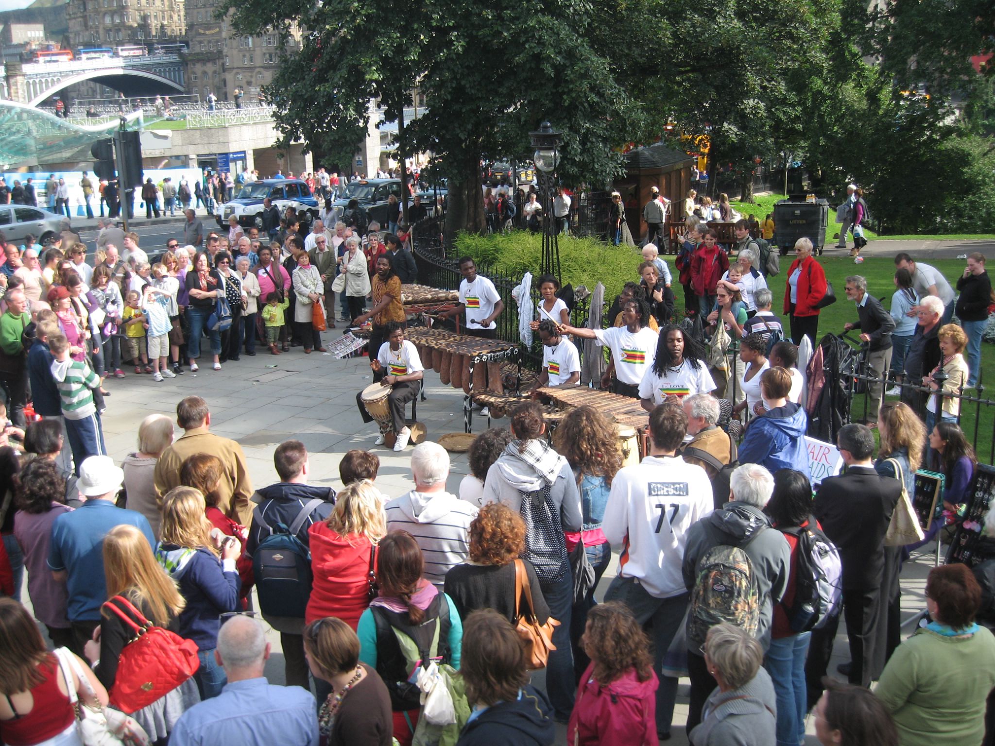 people gathered in the street near many different structures