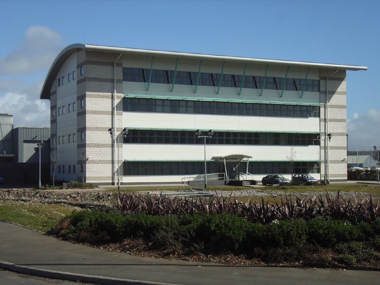 an office building sits near a grass garden