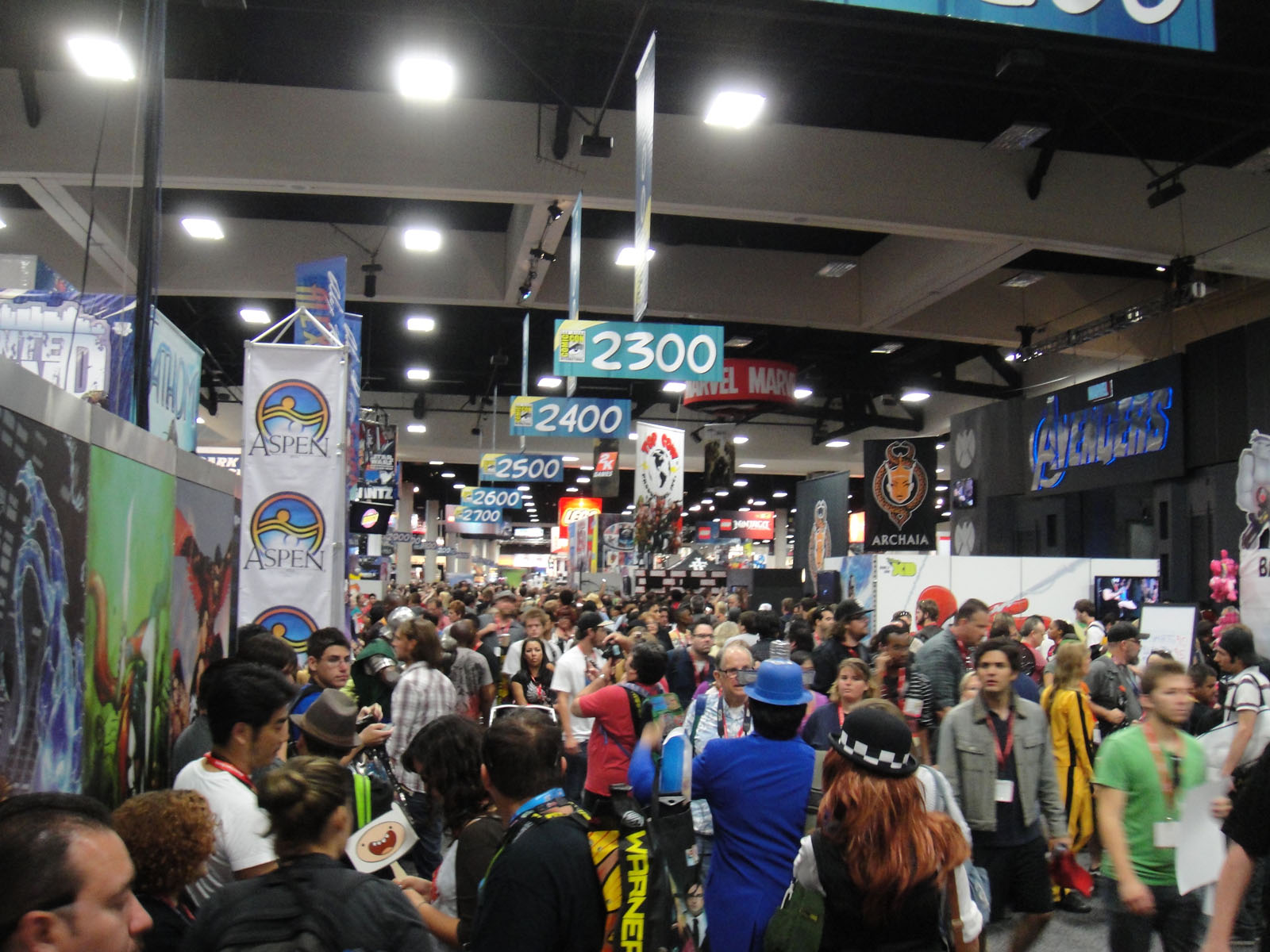 a group of people stand around at a convention