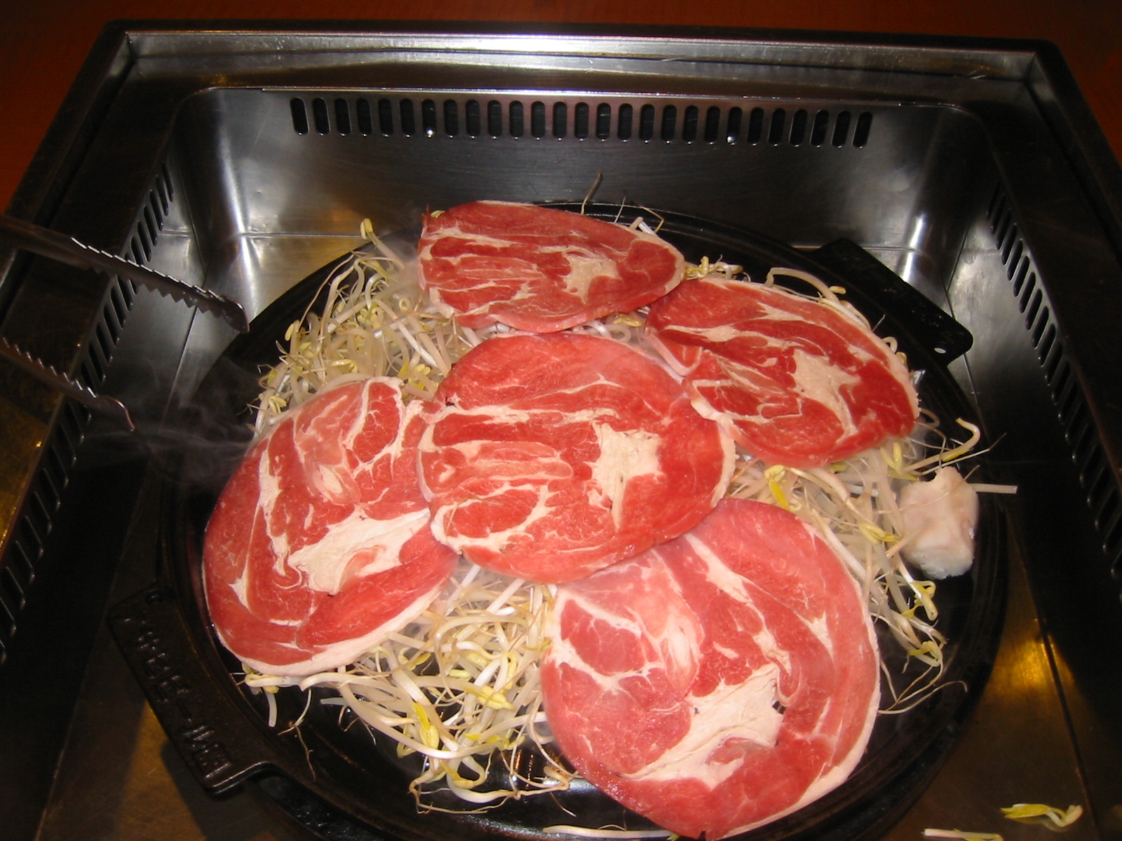 slices of steaks cooking in the oven and sprinkled