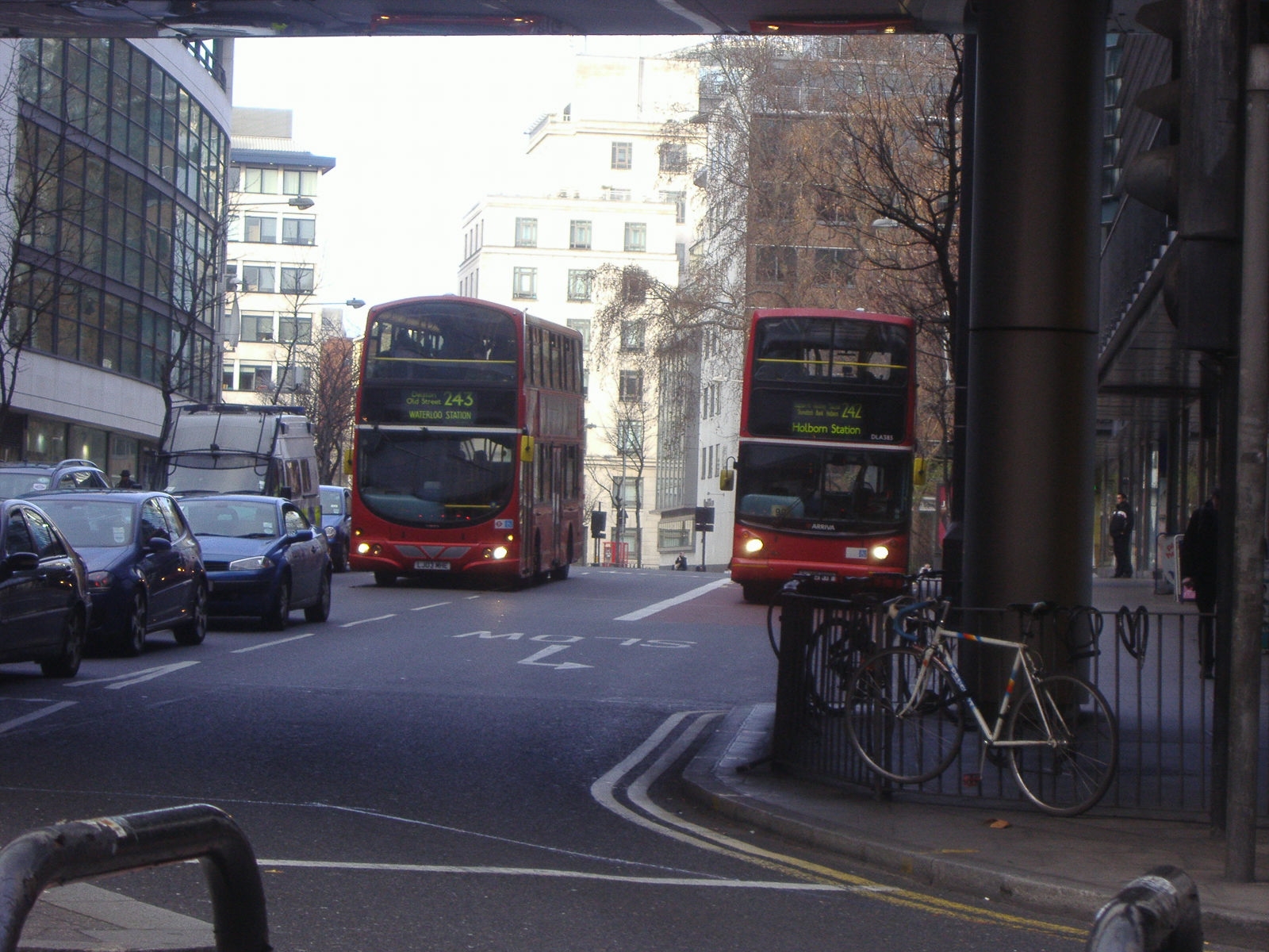 two double deck buses driving down a city street