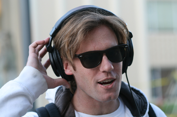 young man listening with headphones and ear buds