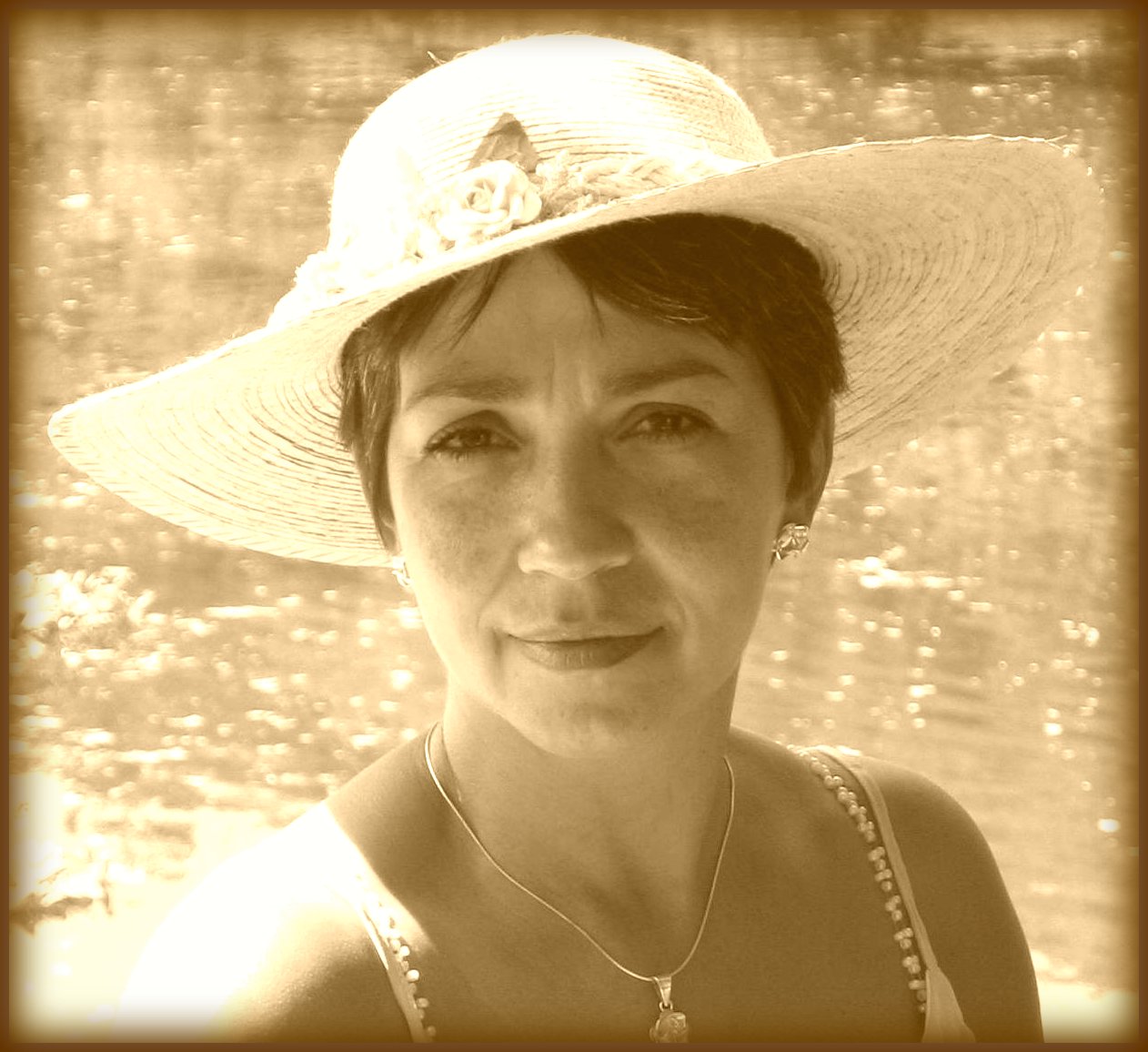 a woman in white hat and blue necklace