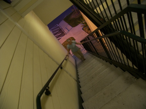 a person with backpack climbing a flight of stairs
