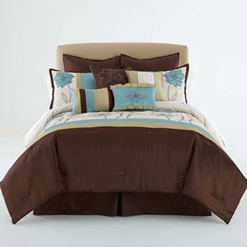 a bed with a brown comforter and a blue throw pillow