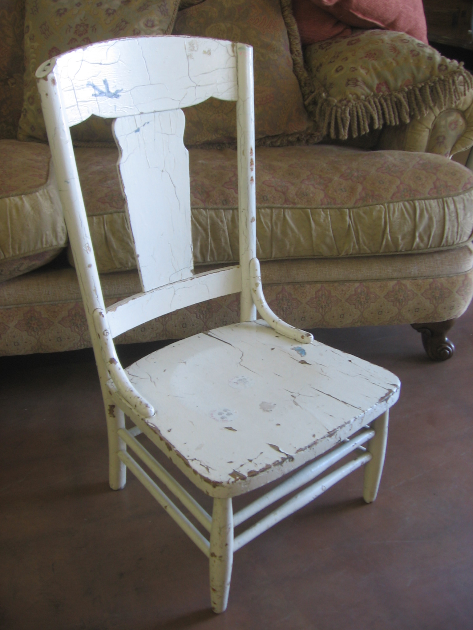 a white wooden chair sitting on top of a floor
