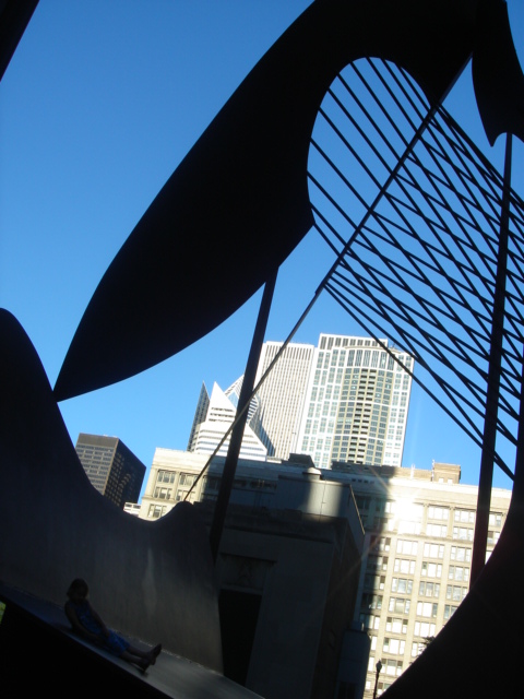 an art sculpture near the city skyline in a glass case