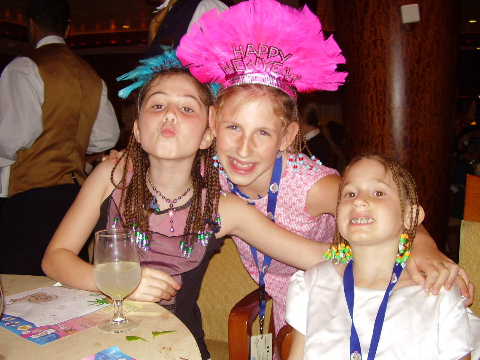 three girls at a birthday party posing for a picture