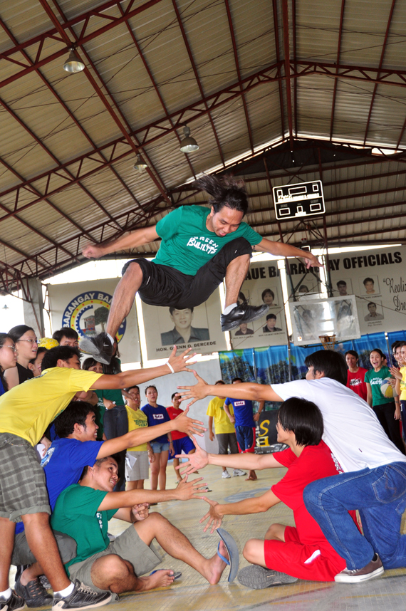 people watch a skateboarder take off in the air