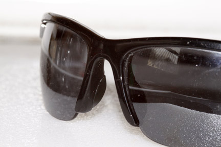 a pair of sunglasses laying on top of a white table