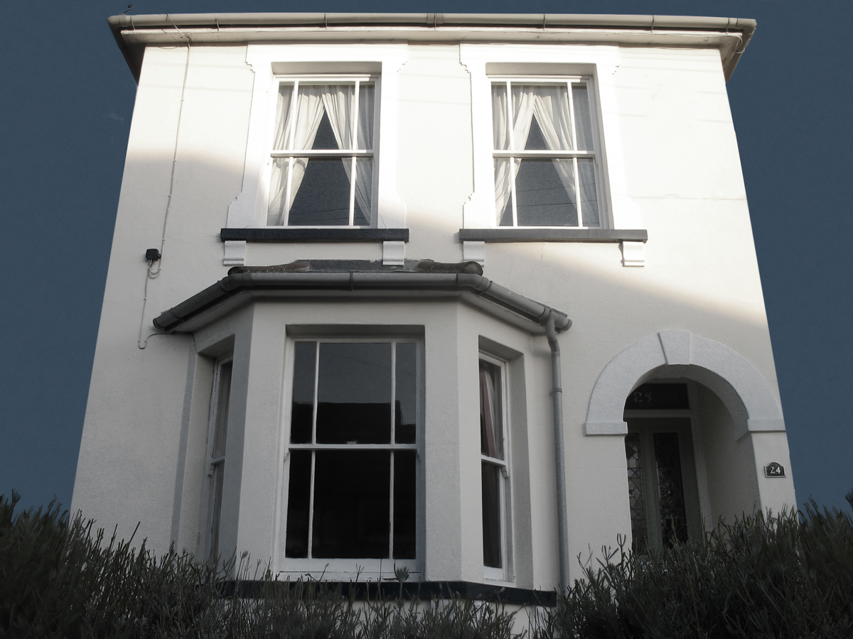 an exterior view of a large white building with two stories