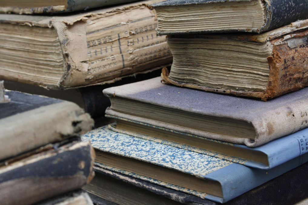 a stack of old books sitting on top of each other