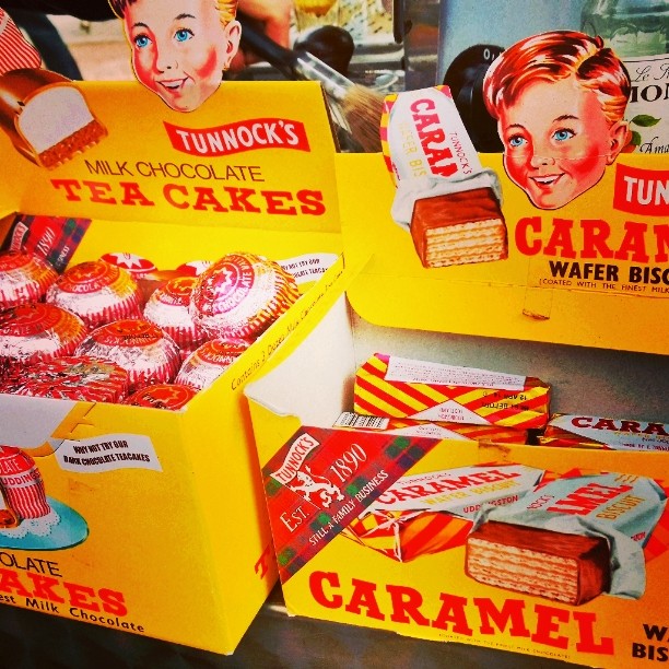 several boxes filled with different kinds of cakes
