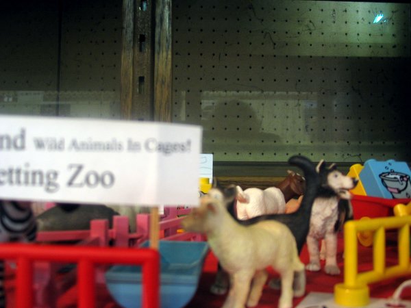 fake goats and sheep toys on display in the window