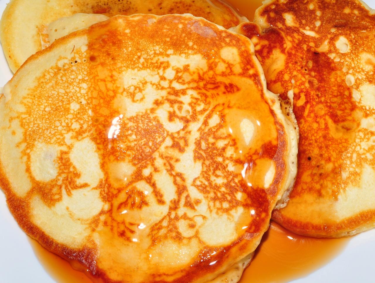 pancakes are topped with syrup on a white plate