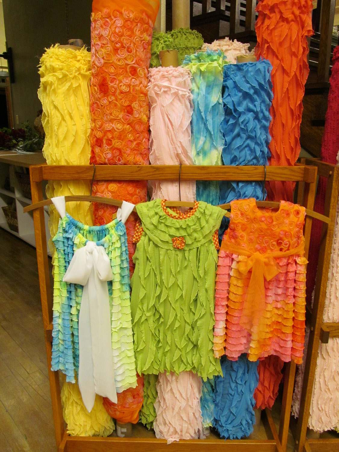 several colorful ones of clothes on display next to each other