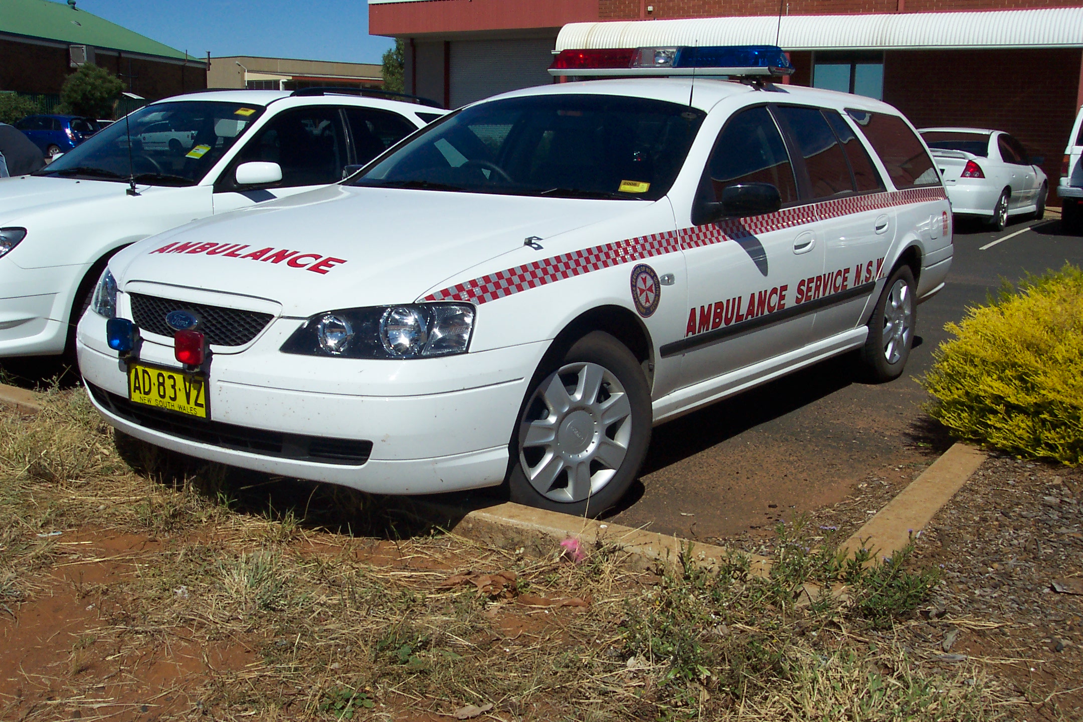 the white police car is parked in front of the firetruck