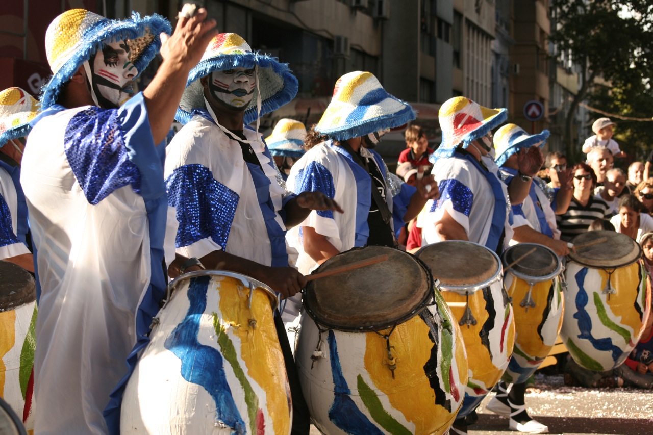 group of colorful performers in an urban parade