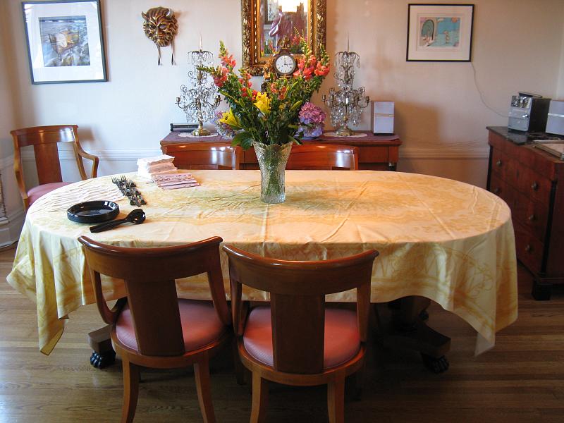 the table is covered with yellow linens and has pink chairs