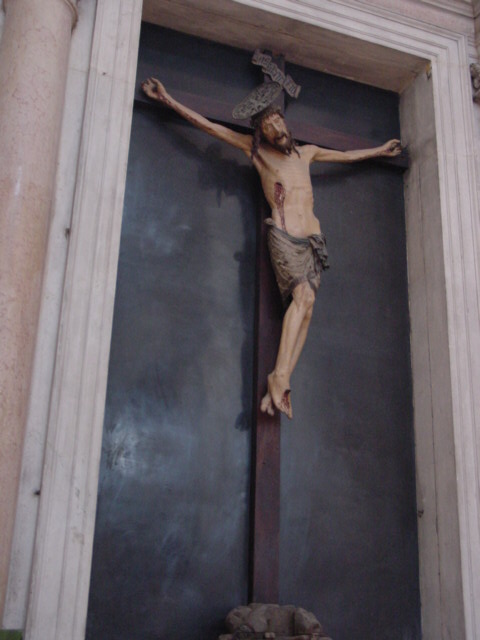 a crucifix with a marble base in a building