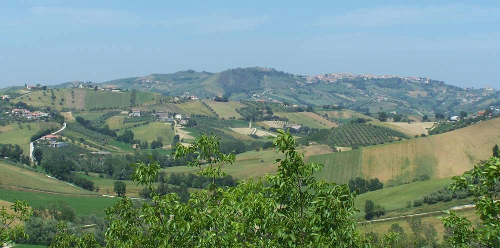 the view from a hill of rolling hills and a village