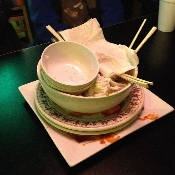 there are bowls and chop sticks that have been placed on a plate