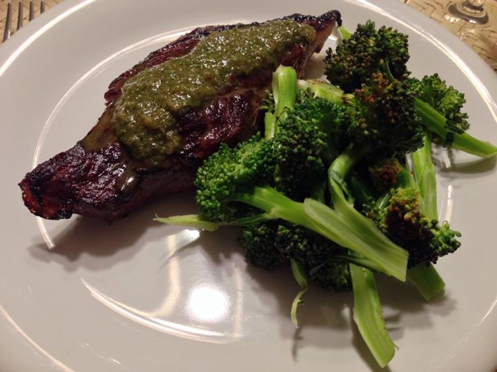 there is a plate with broccoli and steak on it