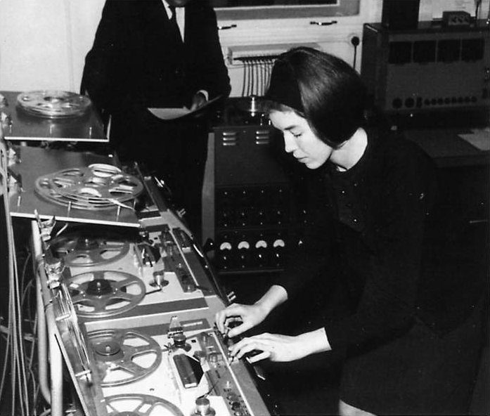 a couple of women standing in front of an old fashioned console