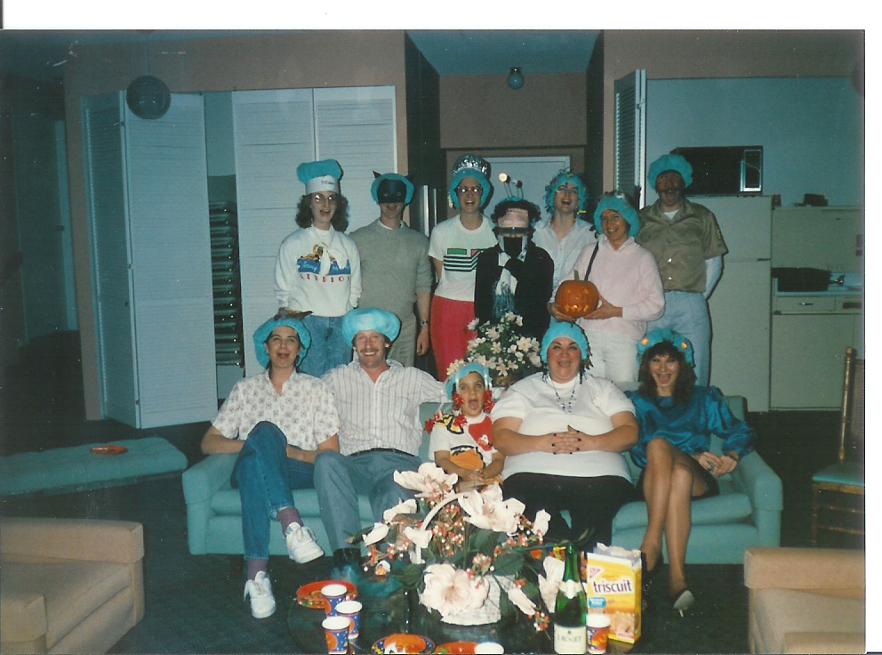 several people posing for a po in front of a family room