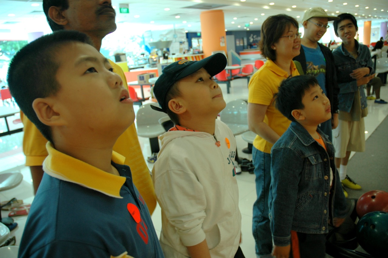 several children watching soing while wearing hats