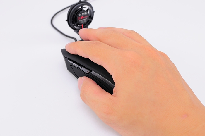 a person's hand holding a computer mouse