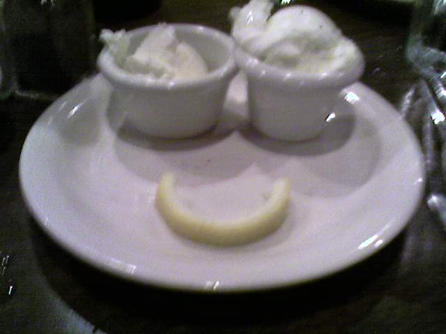 three dessert bowls on a plate with a lemon slice