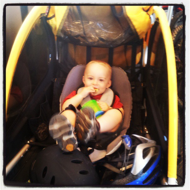 a toddler in a stroller inside a store