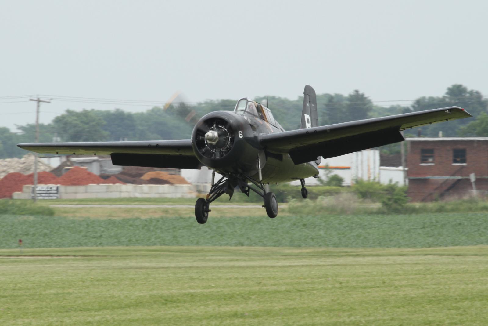 a small plane in the air, taking off