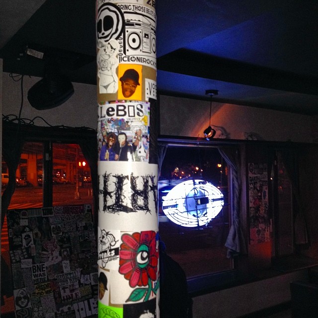 a sticker covered pole with a bunch of images