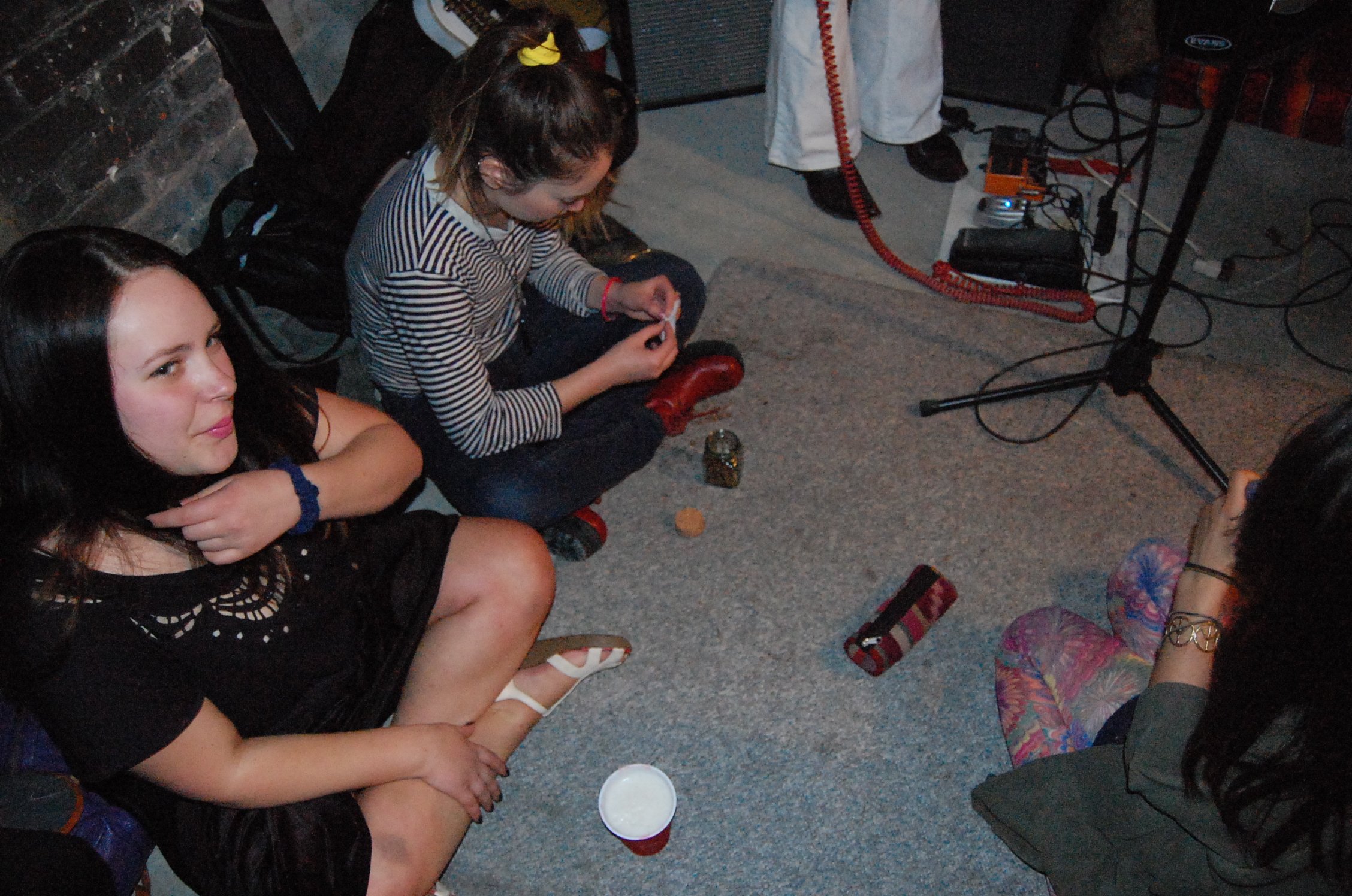 two girls sitting on the floor near the fire place