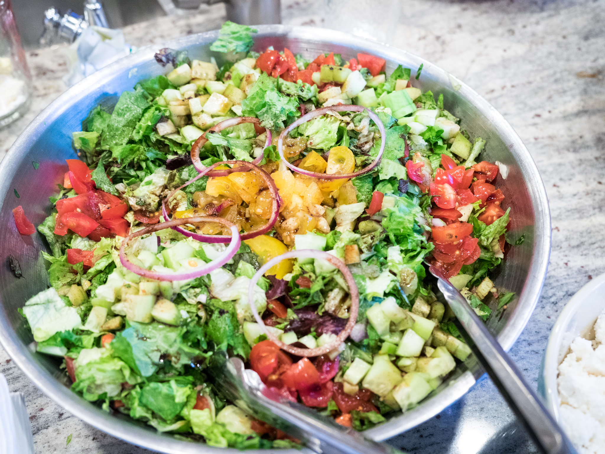 a bowl of vegetables sitting on a table