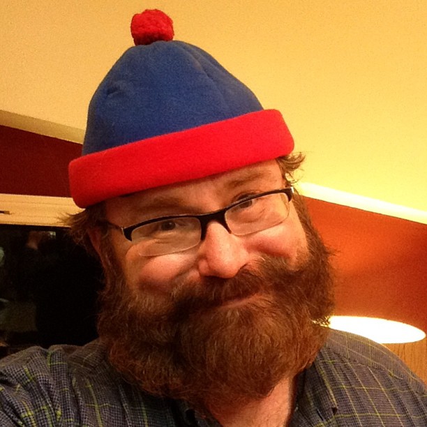 a person with a big beard and wearing a blue hat