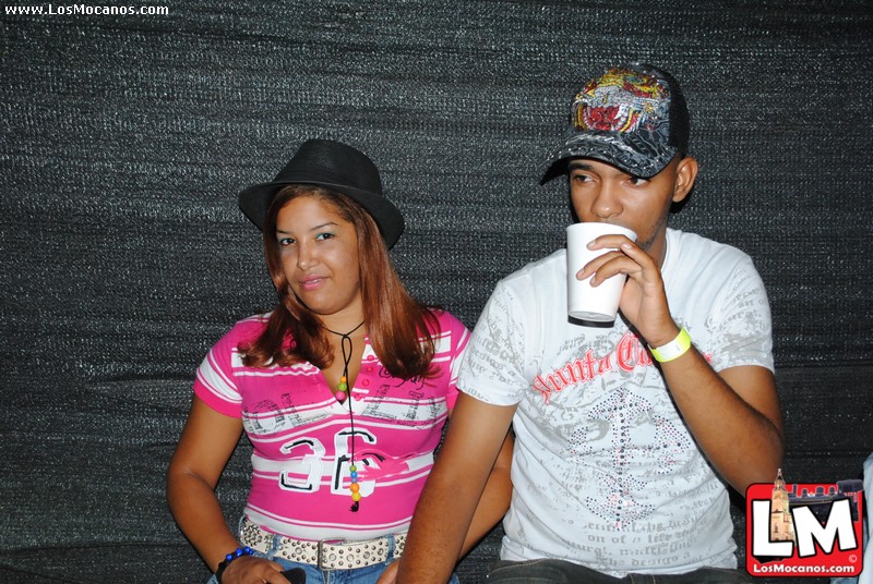 a couple poses for the camera while drinking a beverage