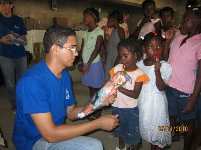 a man holds a bottle while other children look on
