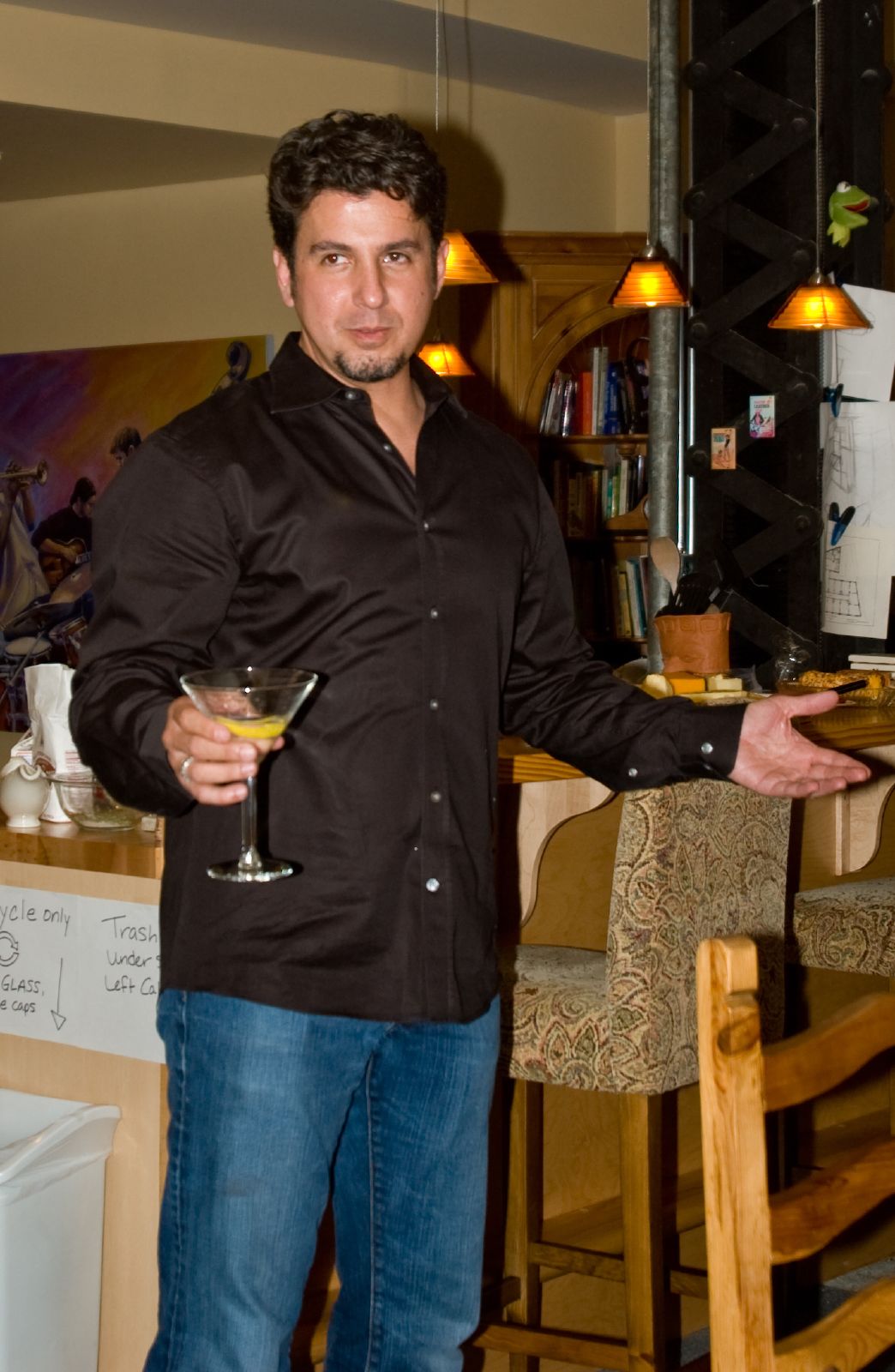 a man holding a glass of martini in his hand