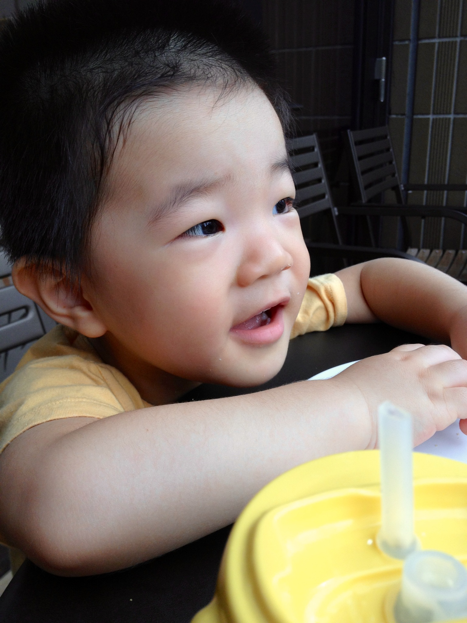 a small boy is sitting at a table