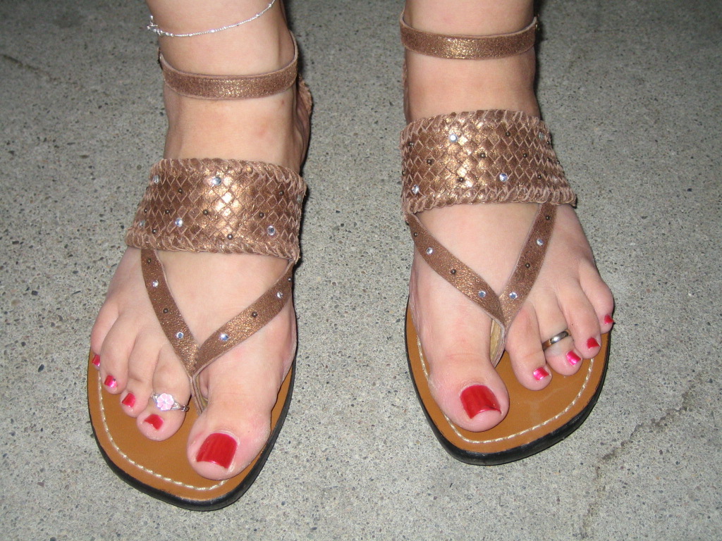 a close up view of sandals on someone's feet