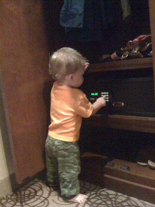 a baby boy touching the keys in a closet