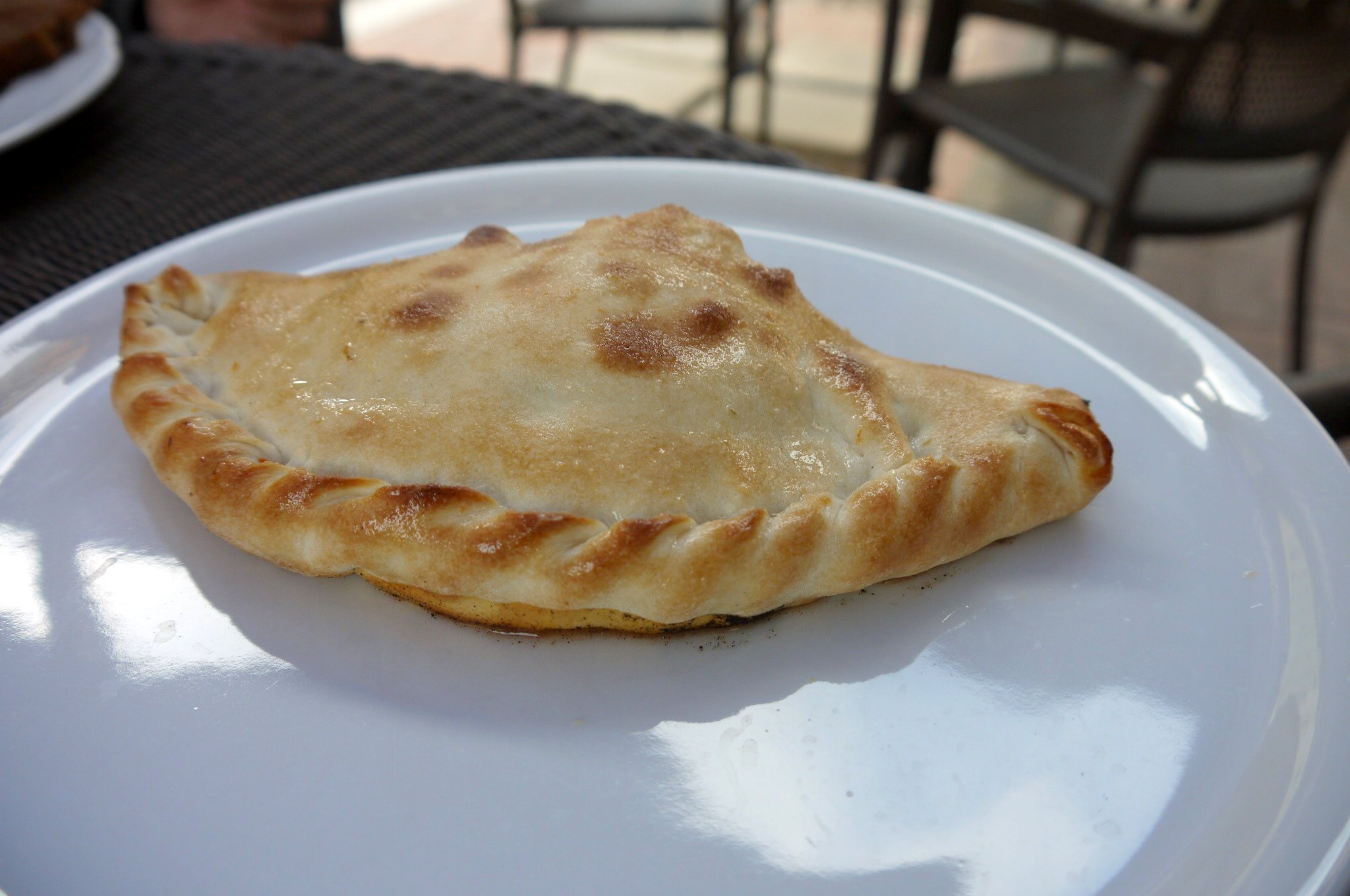 a baked food item sitting on top of a white plate