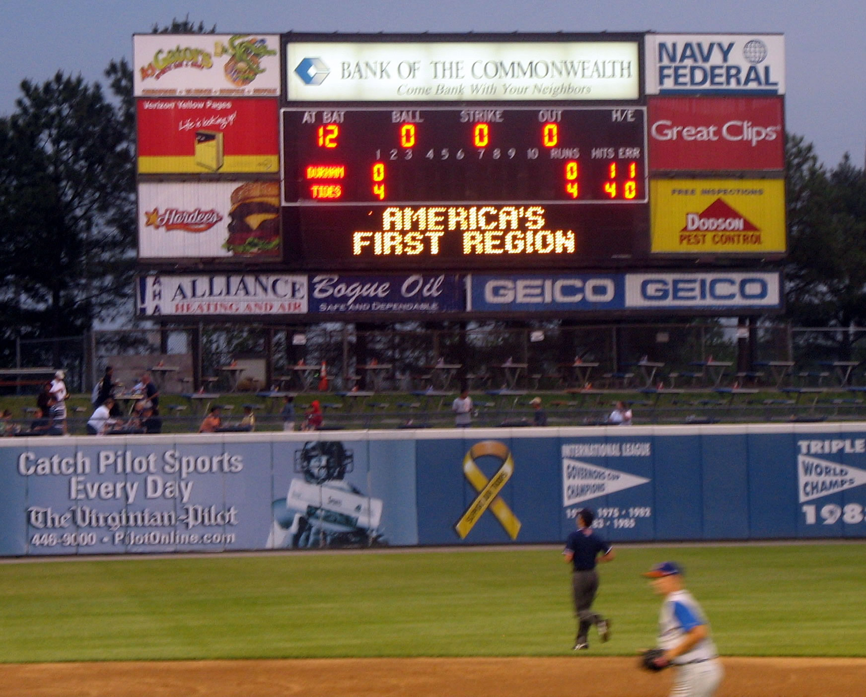 a baseball game with the scoreboard at the stadium