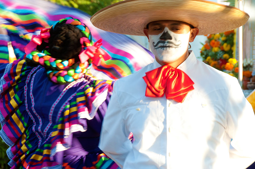 a man wearing a sombrero and skeleton make - up for an event