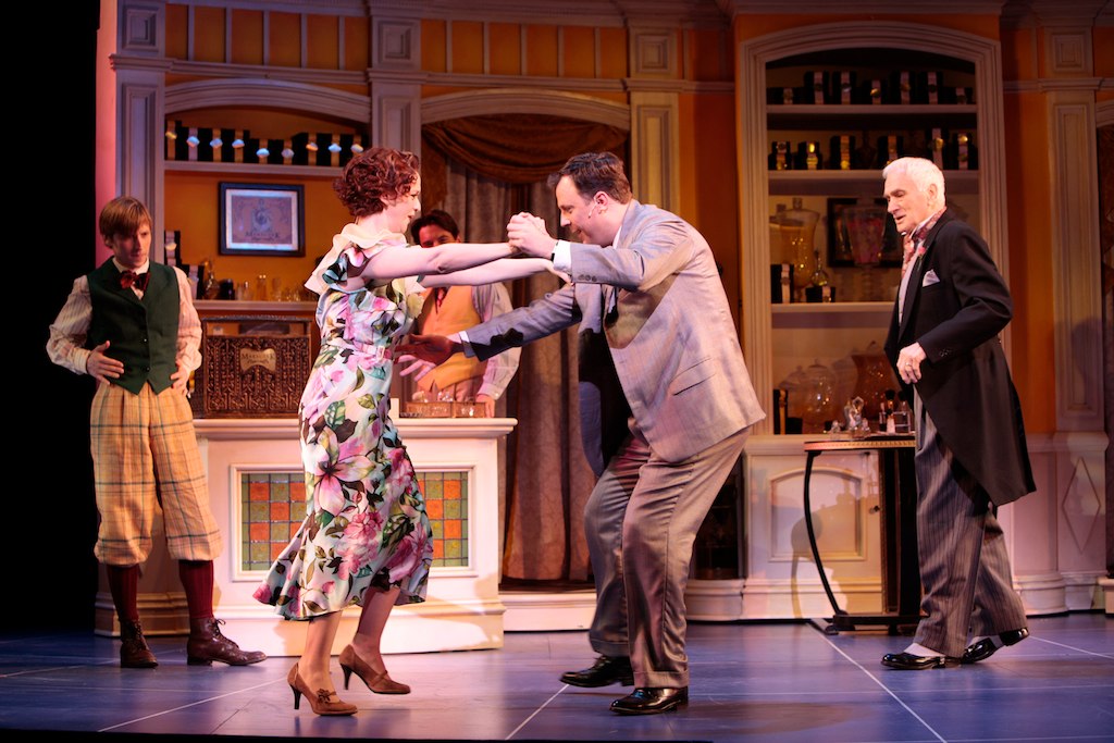 a man and woman in tights are dancing on stage